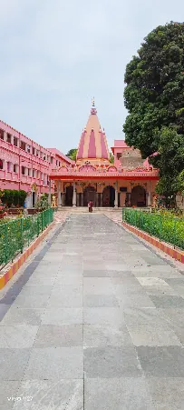 Temple facade with pink domed spire at Bharat Sevashram Sangha Prayagraj